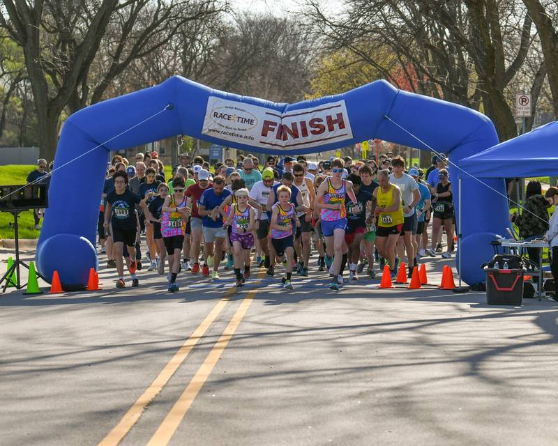 Participants in the Mustang Trot start the race on Sunday April 14, 2024, held at Downers Grove South High School.