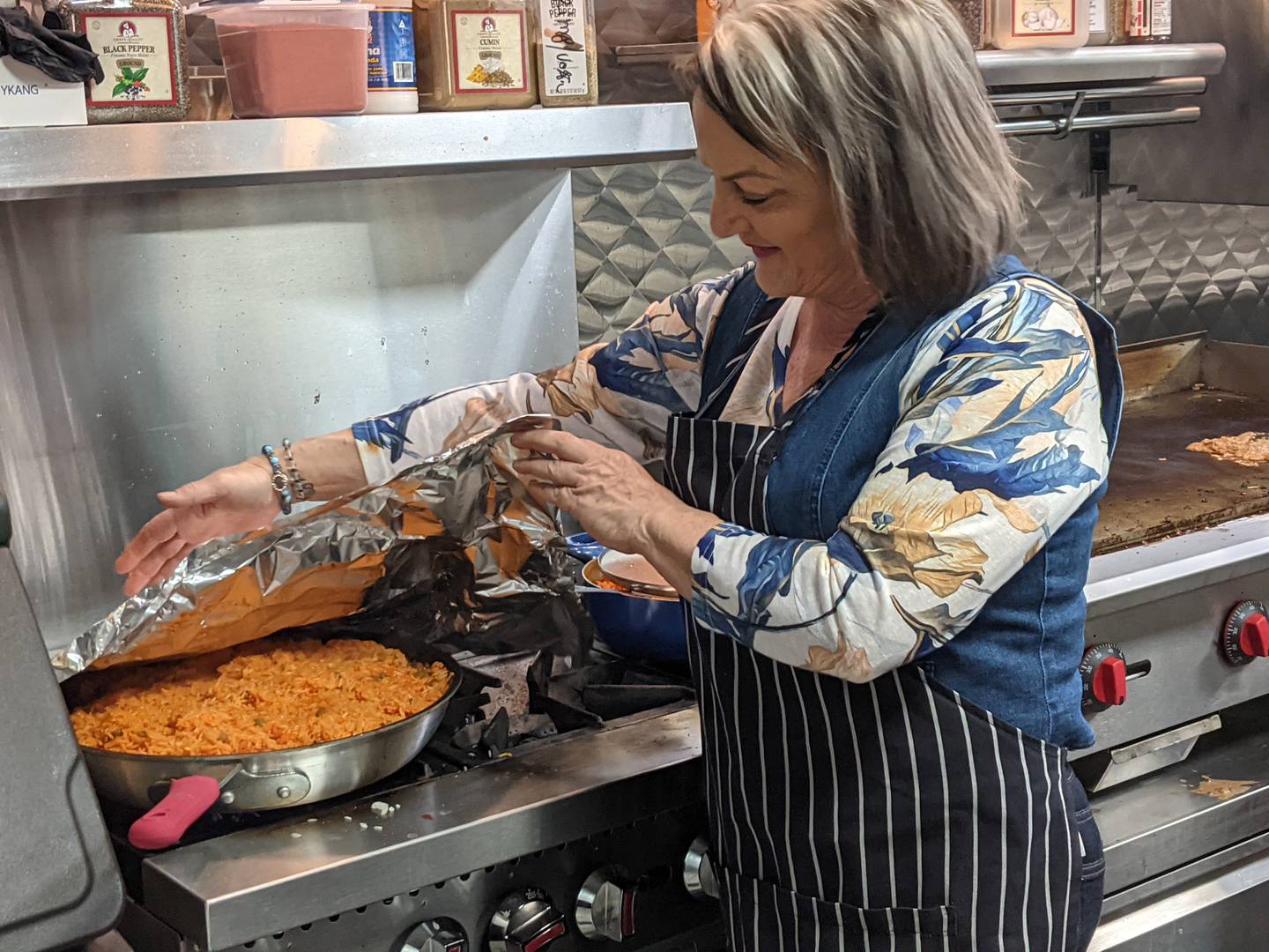 Freddie's Off The Chain owner Mona Herrada prepares rice for the restaurant's opening day on April 1.