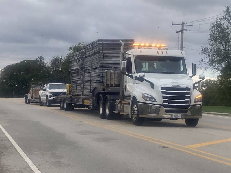 A truck carrying fencing heads towards the Joliet Local Training Area site for the Illinois National Guard at 20612 Arsenal Road in Elwood on Tuesday, Oct. 7, 2025.