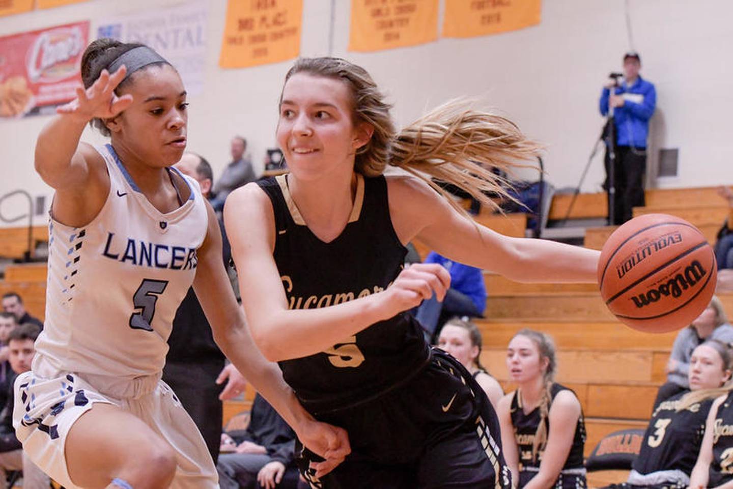 Lake Park's Gabi Burgess (5) guards Sycamore's Faith Feuerbach (5) as she drives toward the basket during the Inaugural MLK Day Conference Challenge at Batavia High School on Monday, Jan. 20, 2020 in Batavia.