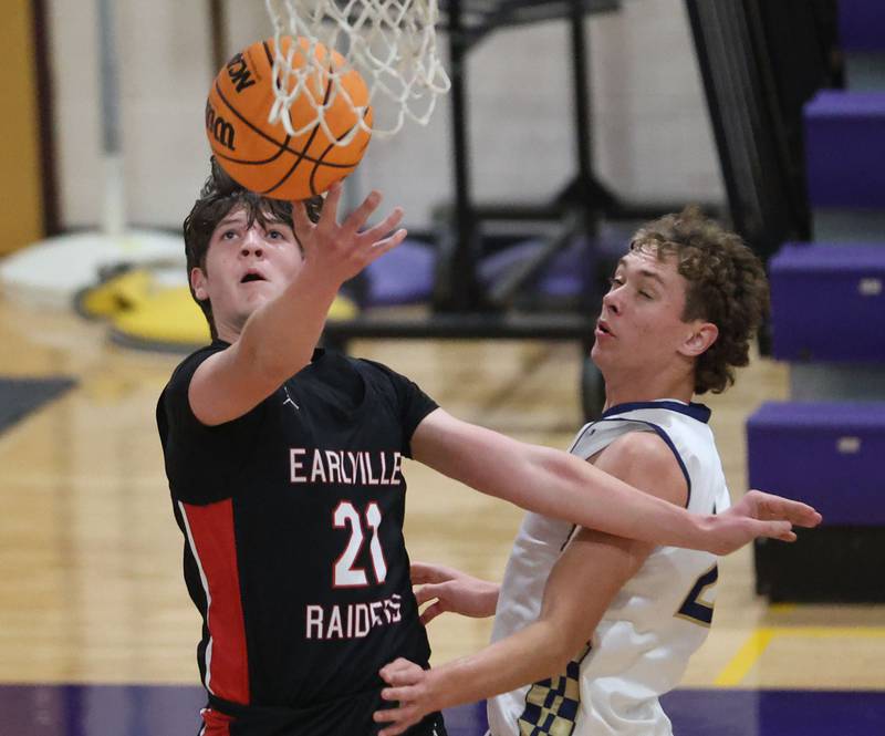 Earlville's Landen Tirevold lets go of a shot under the hoop as Marquette's Lucas Craig defends during the Huskers Hardwood Tip-Off Tournament on Tuesday, Nov. 25, 2025 in Serena.