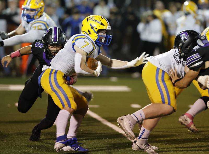 Lyons' Danny Carroll (7) looks for an opening as the Downers Grove North defense closes in during the varsity football game between Downers Grove North and Lyons Township on Friday, Oct. 11, 2024 in Downers Grove.