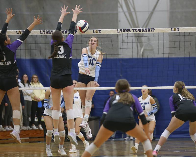 Downers Grove South's Zoe Grams (18) hits a kill past the block attempt by Downers Grove North's Nora Benjamins (13) during Class 4A Lyons Sectional Semifinal volleyball match between Downers Grove South at Downers Grove North. Nov 4, 2025 in La Grange.