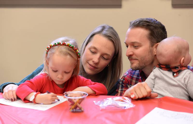 (Left to right) Kalli, Hannah, Matt and James Nies of Downers Grove help Kalli write her wish list to Santa while attending Downers Grove Park District's Candy Cane Lane Saturday, Dec. 2, 2023.