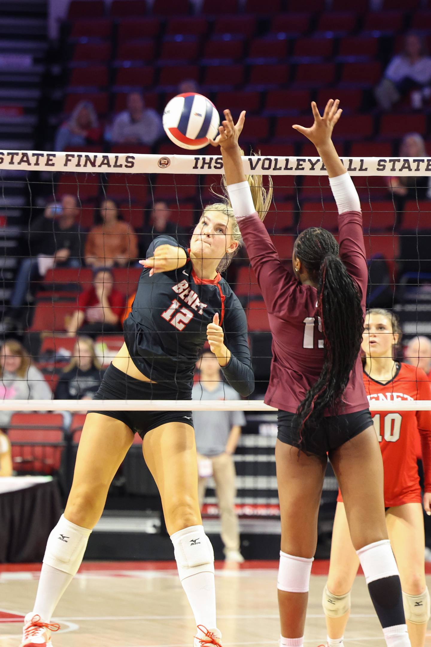 Benet Academy's Lynney Tarnow spikes against a block by Lockport's Malia Cole during Benet Academy's victory in two sets, 25-23, 25-16, over Lockport in the IHSA Class 4A State semifinals on Friday, Nov. 14, 2025.