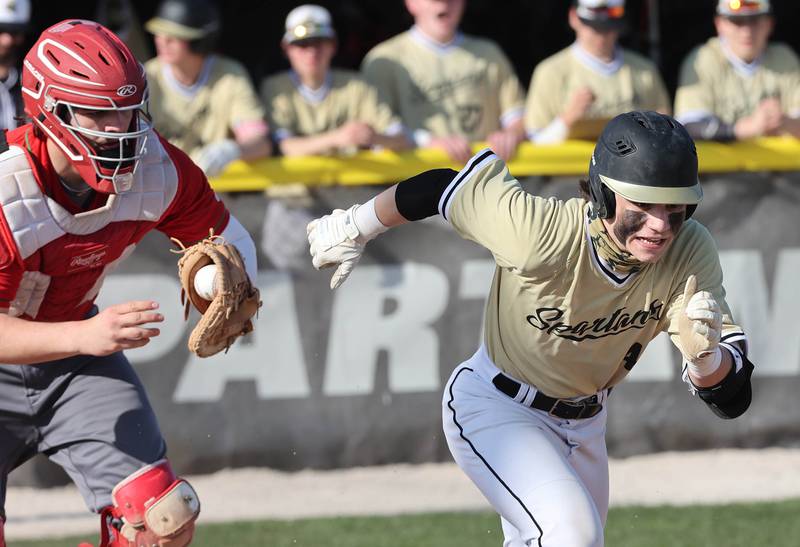 Sycamore's Hunter Britz runs to first as LaSalle-Peru's Aidan VanDuzer tries to make the tag after a dropped third strike during their game Monday, April 11, 2022, at the Sycamore Community Sports Complex.