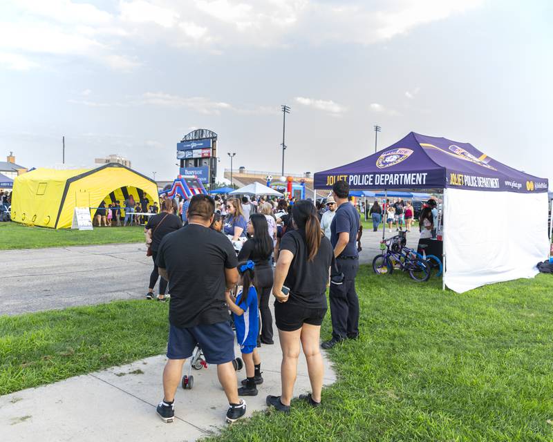 People stand in line to enter the raffle to win two bicycles and ar ring doorbell at the Joliet Police Department's National Night Out event Tuesday, Aug 5, 2025  in Joliet.