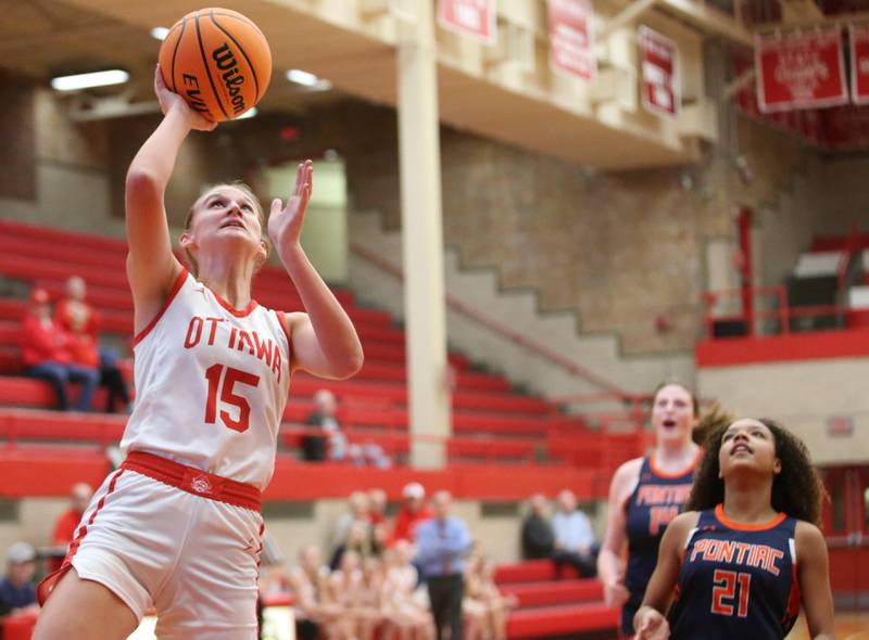 Ottawa's Hailey Larsen eyes the hoop as Pontiac's Trinity Miller trails behind during the Ottawa Girls Holiday Tournament on Monday, Dec. 16, 2024 in Kingman Gym at Ottawa High School.