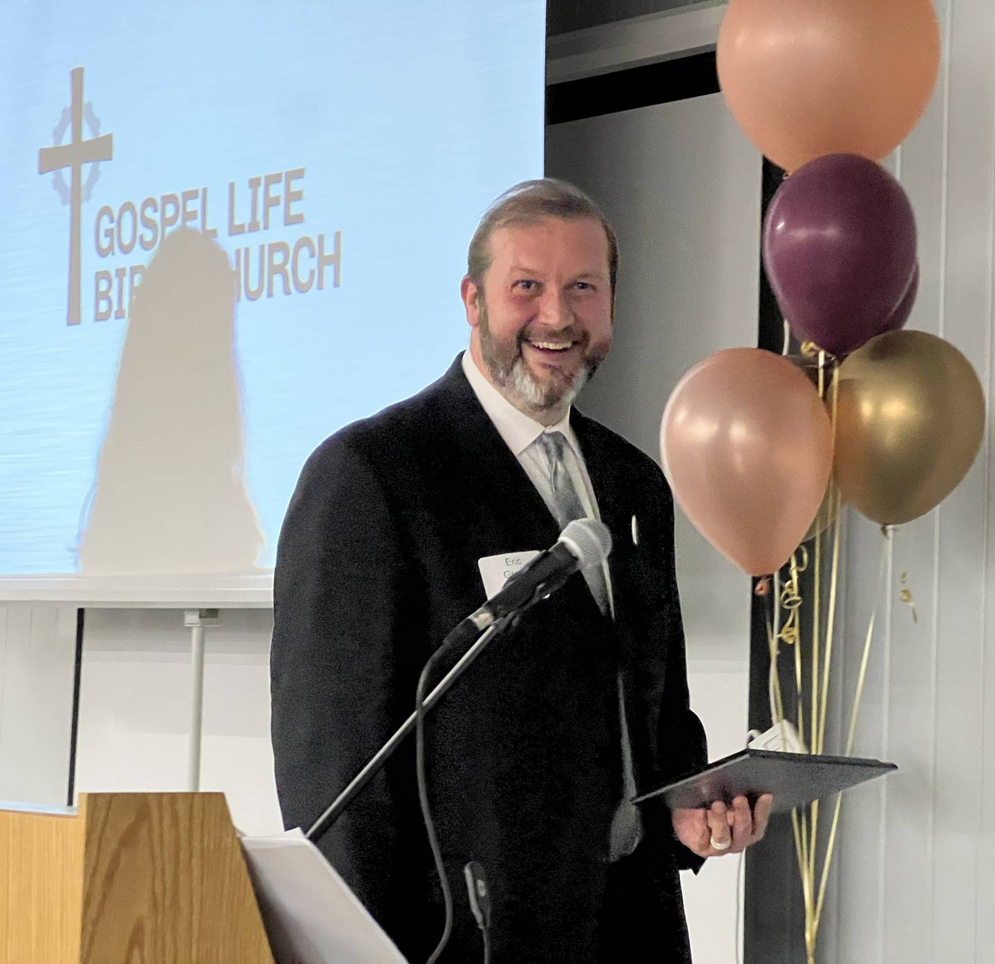 Eric Groce, with Gospel Life Bible Church, smiles as he approaches the podium after his church was announced as the winner of the 2024 nonprofit award on Feb. 21, 2024.