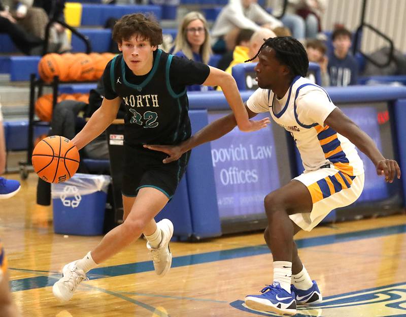 Woodstock North's Ben Hendershot pushes th ball up the court agains tJohnsburg's Jarrel Albea during a Kishwaukee River Conference boys basketball game on Monday, Dec. 15, 2025, at Johnsburg High School.
