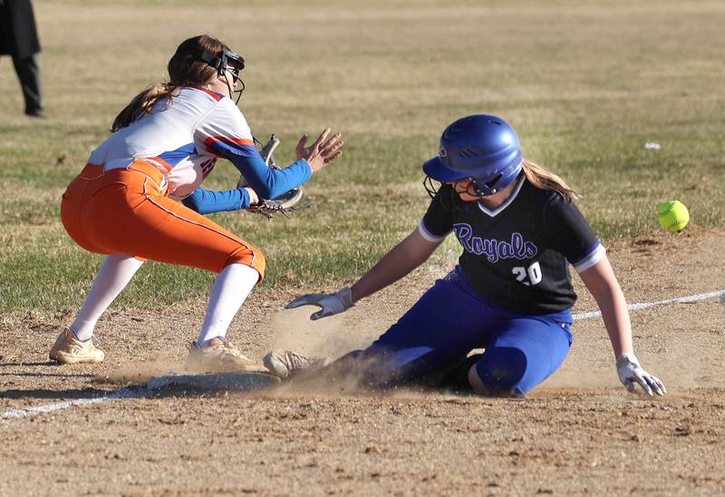 Hinckley-Big Rock's Cailyn Mrowczynski slides in safely at third as Genoa-Kingston's Lilyana Stiles takes the throw Monday, March 23, 2026, during their game at Hinckley-Big Rock High School.