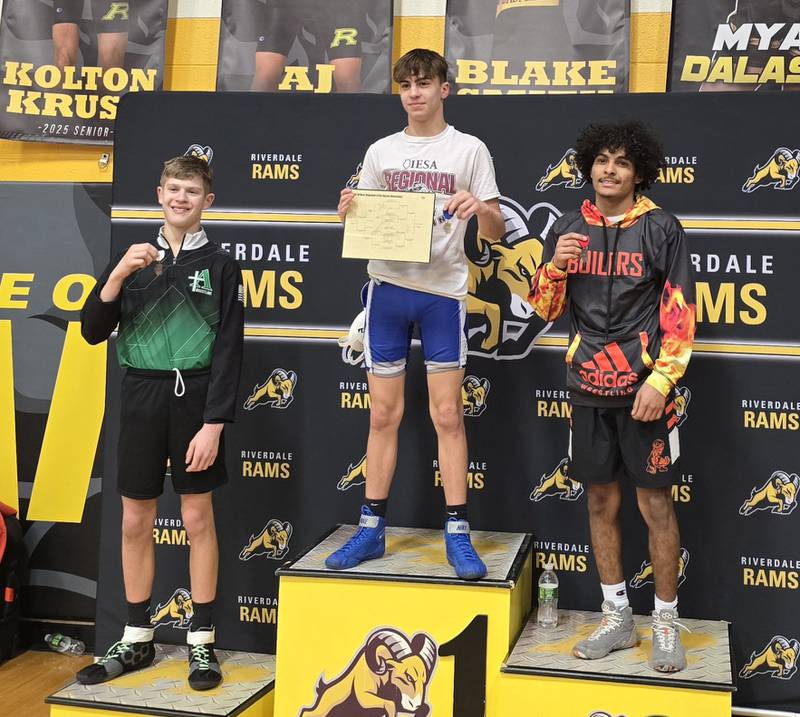 Newman freshman Javen Reyes, center, is pictured after winning the Class 1A Riverdale Regional wrestling title at 113 pounds on Saturday, Jan. 8, 2025.