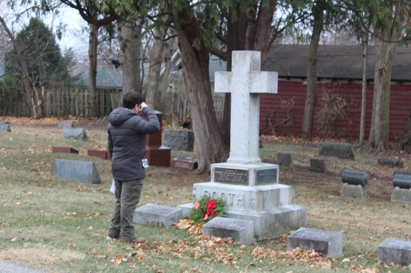 A Boy Scout from Troop #165 salutes to a Gold Star veteran's headstone during the Wreaths Across America ceremony in Crystal Lake on Dec. 14, 2024.