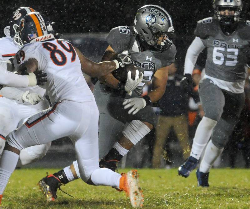 Oswego East running back Oshobi Odior (23) gets past the grab by Oswego defender Taiden Thomas (89) during a varsity football game at Oswego East High School on Friday, Oct. 14, 2022.