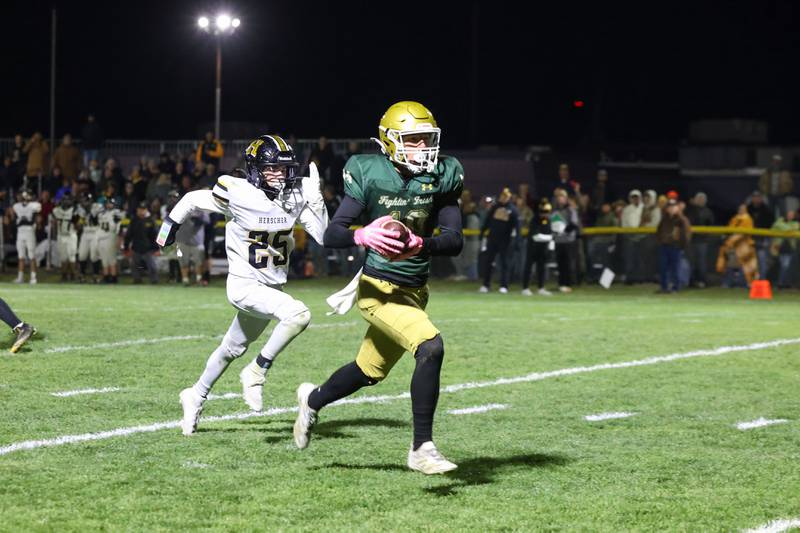 Bishop McNamara's Coen Demack breaks away for a touchdown after a reception ahead of Herscher's Mason Roberts during Bishop McNamara's 38-14 victory in the IHSA Class 3A first round playoff game on Friday, Oct. 31, 2025.
