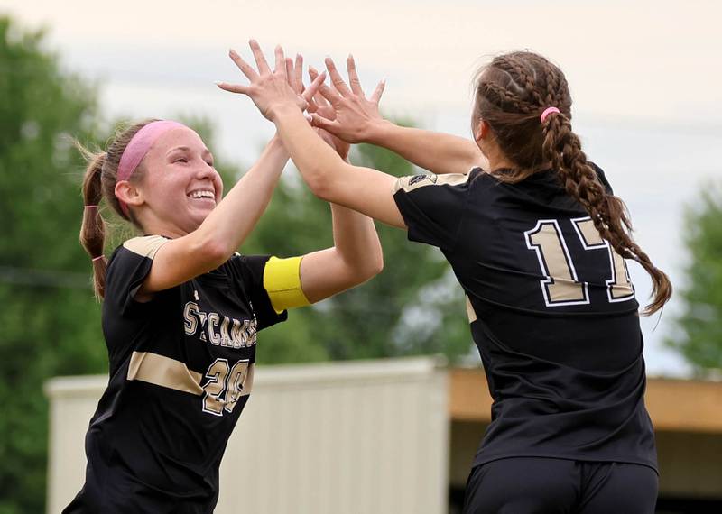 Sycamore's Addison Rodriguez (right) gets a high five after scoring a goal against Rock Island from teammate Cortni Kruizenga Friday, May 22, 2026, during their Class 2A regional championship matchup at Sycamore High School.