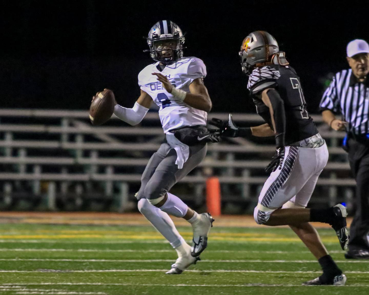 Oswego East's Robert Tyre Jones III (9) looks for an open receiver during varsity football game between Oswego East at Minooka.  Sept 30, 2022
