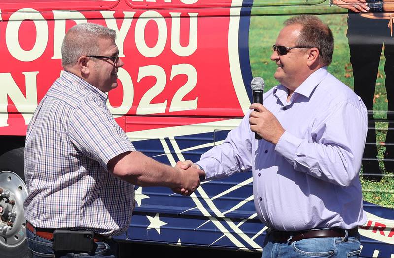Candidate for Illinois attorney general Thomas Devore introduces Darren Bailey, a Republican candidate for Illinois governor, Friday, June 17, 2022, during a campaign stop at Tom and Jerry's in Sycamore. Bailey is currently on a bus tour across the state that will cover 102 countys in 14 days.