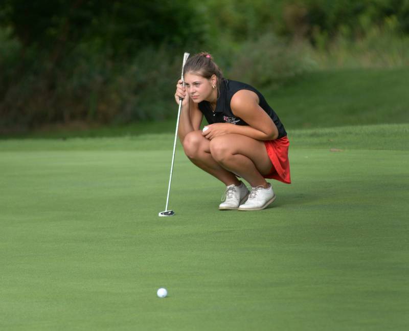 Erie-Prophetstown's Izzy Johnston reads the green before putting at a Monday, Aug. 18, 2025 match with Oregon High School at Silver Ridge Golf Course north of  Oregon.