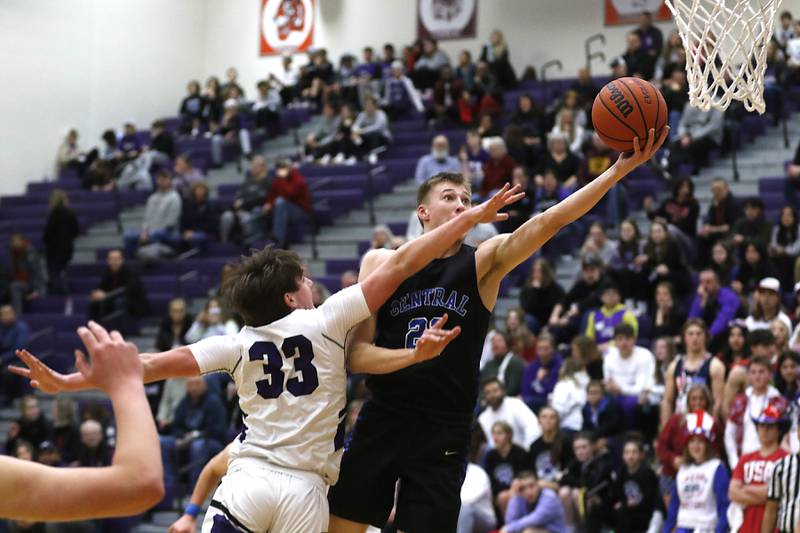 Burlington Central's Andrew Scharnowski shoots the basket ball over Hampshire’s Sam Ptak during a Fox Valley Conference boys basketball game Friday, Jan. 20, 2023, at Hampshire High School.