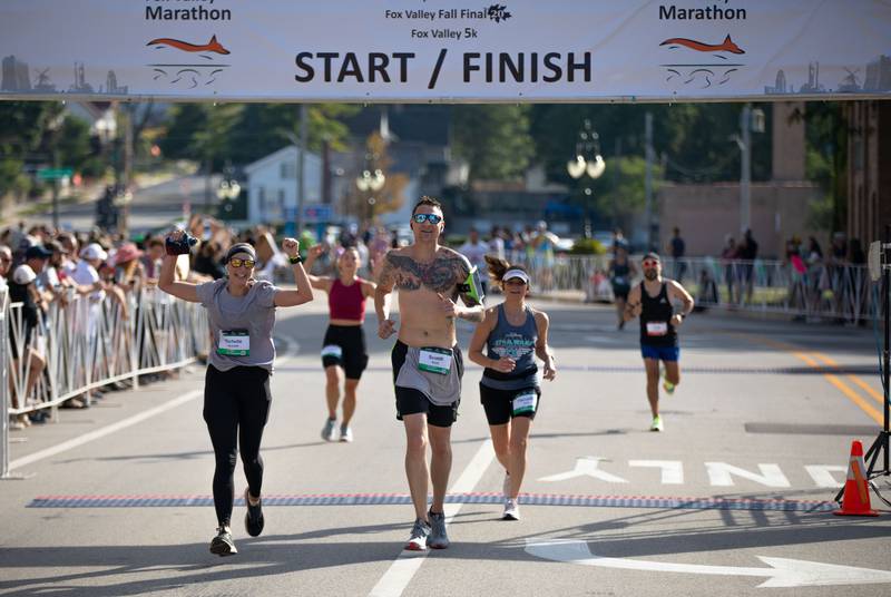 A Fox Valley Marathon runners cross the finish line on Sunday, Sept. 18, 2022.