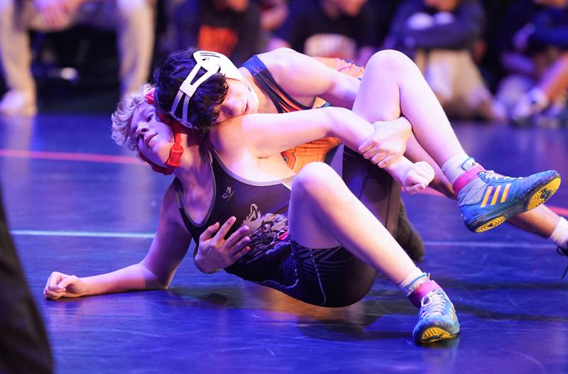 Oswego’s Vincent Manfre fights for position over Oswego East's Braeden Grisham in their 126 pound match during a wrestling meet at Oswego High School in Oswego on Thursday, Jan 11, 2024.
