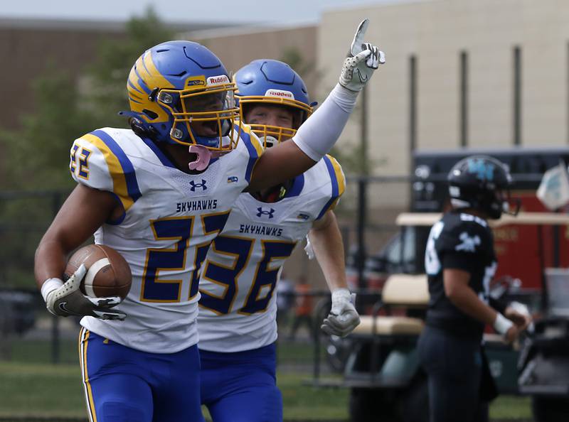 Johnsburg's Dominic Vallone celebrates his fumble return for a touchdown with his teammate, Deegan Turner, during a Kishwaukee River Conference football game against Woodstock North Saturday, Aug. 26, 2023, at Woodstock North High School.