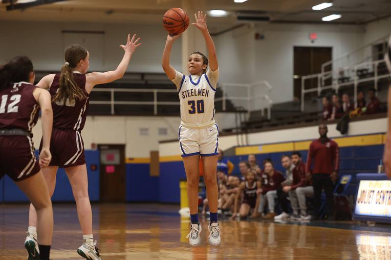Joliet Central’s Nevaeh Wright hits a critical three point shot in the final minute against Lockport.