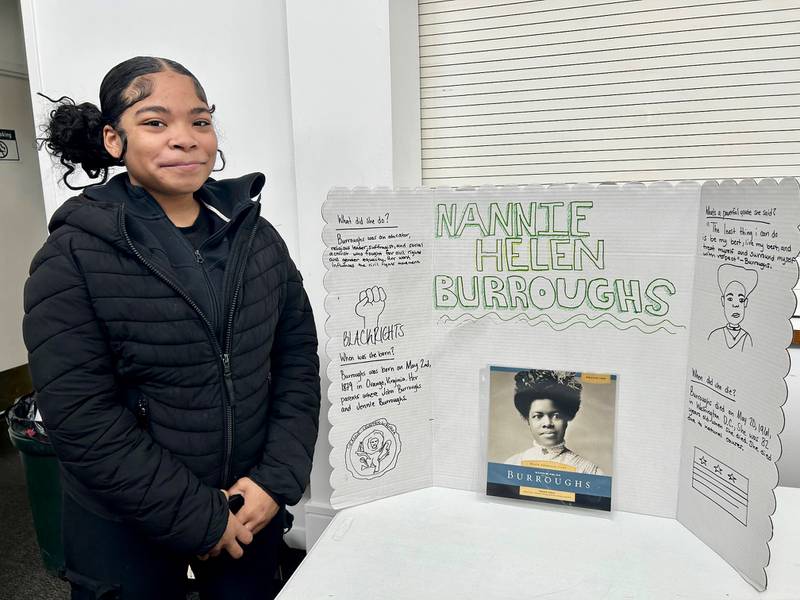 Amiya Jones poses next to her poster board about Nannie Helen Burroughs, a civil rights-era educator who founded the Washington, D.C.-based National Training School for Women and Girls. Jones' work was part of the "Displays of Excellence" event on Sunday, Feb. 17, 2025, at New Hope Missionary Baptist Church in DeKalb, part of the church's annual Black History Month programming.