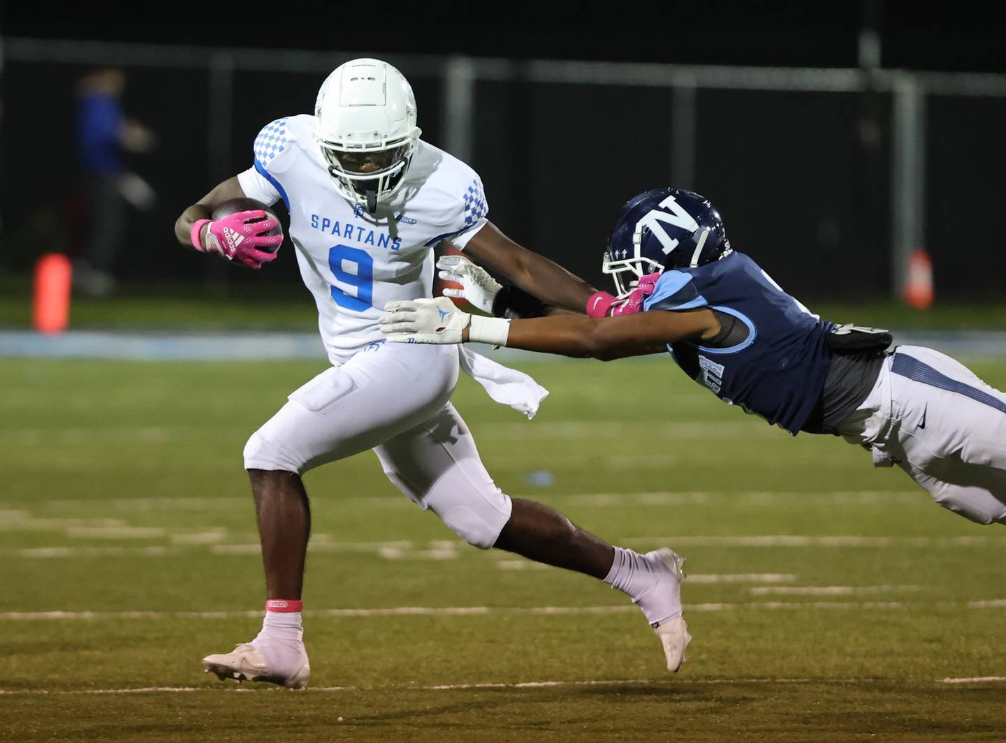 St. Francis’ DeShaun Williams (9) breaks a tackle against Nazareth during the boys varsity football game on Friday, Oct. 20, 2023 in La Grange Park, IL.