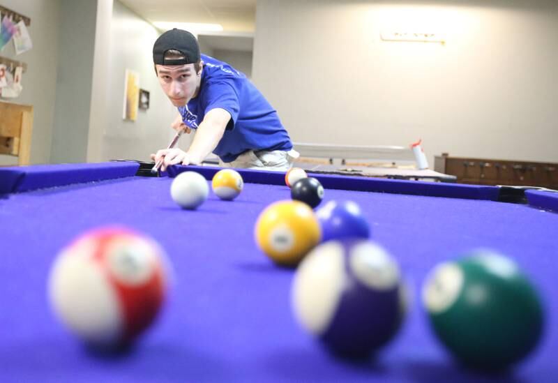 Bradyn Briddick shoots a game of pool at the current Second Story Teen Center above Johnson's Carpet on Wednesday, Aug. 16, 2023 in Princeton.