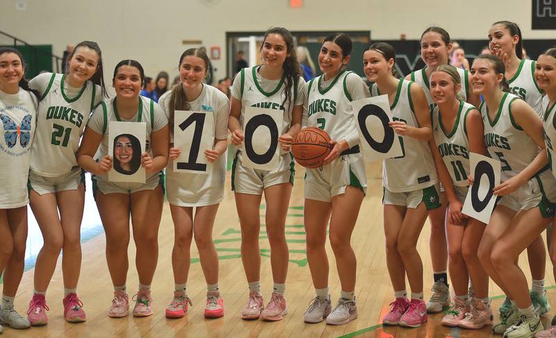 Teammates pose with York’s Anna Filosa (with ball) after she reached the 1000 points mark during a game against Lyons Township on February 4, 2025 at York High School in Elmhurst.