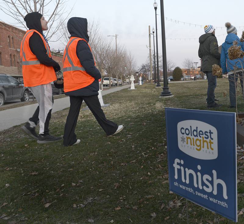 Walkers who participated in “The Coldest Night Of The Year” ,  make it to the finish line at the Jordan Block in Ottawa Saturday where they could have a hot drink and snack. he fundraising event contributed to the vital needs to support the growing homeless population in the Illinois Valley area.