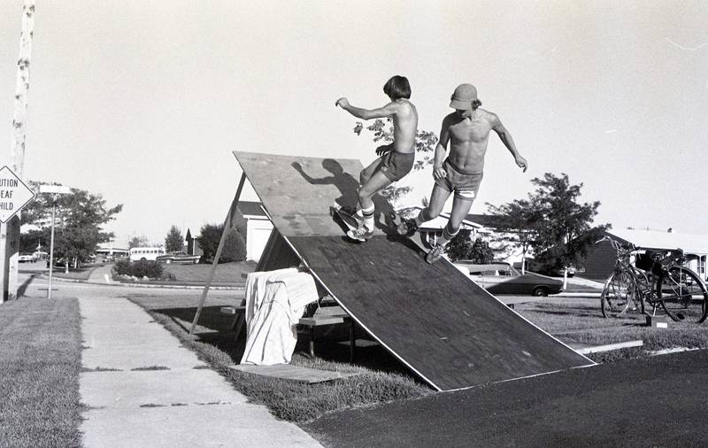 Kevin Ainsworth and Alphone Han practice skateboarding at the corner of Pine Street and Fairland Drive in Sycamore in August 1977.