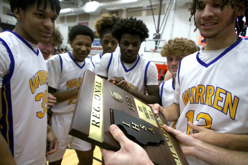Warren’s Blue Devils celebrate a win over McHenry in IHSA Class 4A Regional Title Game boys basketball action on Friday, Feb. 28, 2025 at McHenry High School in McHenry.