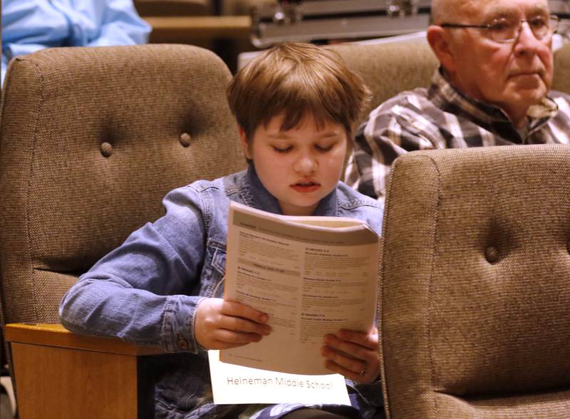 Elsie Smith of Heineman Middle School in Crystal Lake studies the spelling words minutes before the start of the McHenry County Regional Office of Education's 2023 spelling bee on Wednesday, March 22, 2023, at McHenry County College's Luecht Auditorium in Crystal Lake.