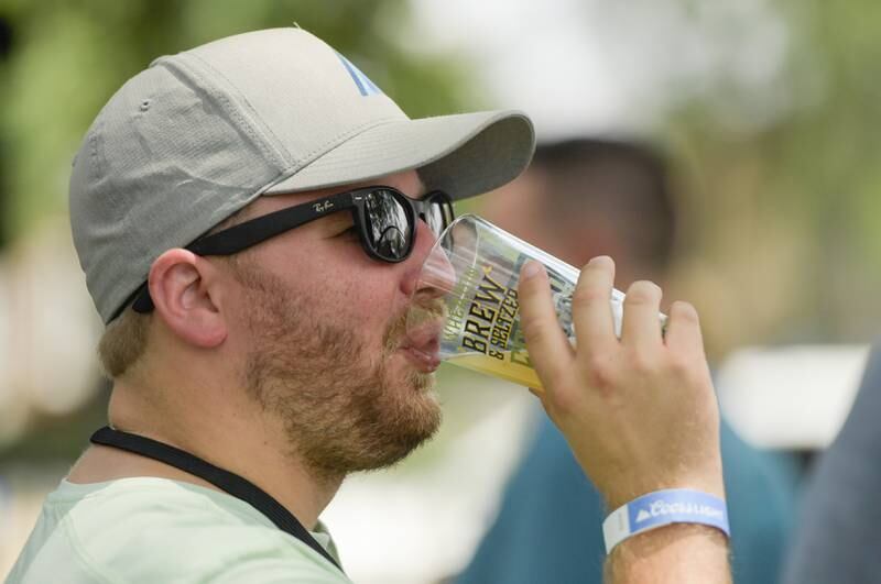 Brian Albertsen of Chicago tastes one of the many craft beers available at the Wheaton Brew and Seltzer Fest in Memorial Park on Saturday, August 6, 2022.
