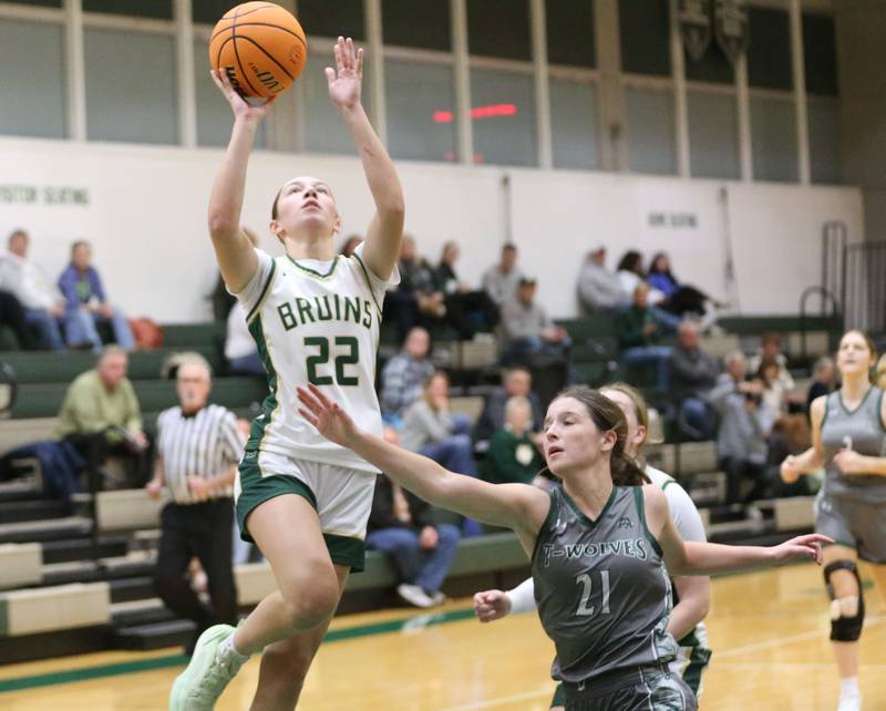 St. Bede's Hannah Heiberger runs in for a layup over Midland's Adalynn Stickel on Thursday, Dec. 4, 2025 at St. Bede Academy.