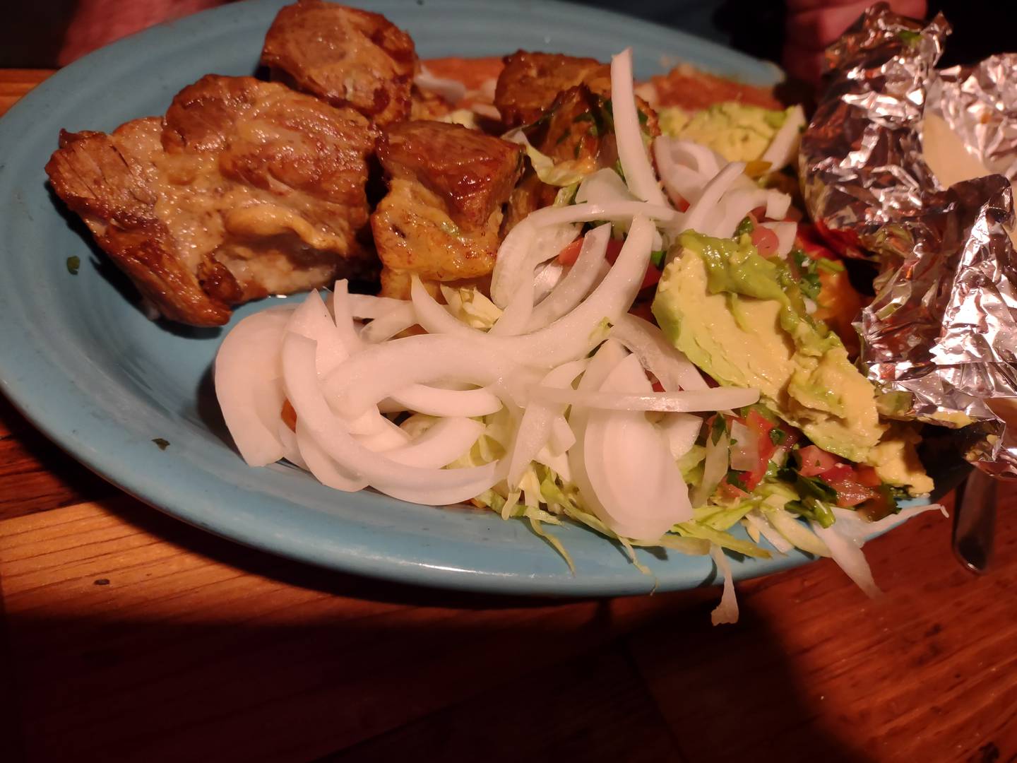 The carnitas at La Fondita Mexican Grill in Ottawa are pork tenderloins simmered in beer with jalapenos and avocado slices, and plenty of onions. The meal is served with rice, beans and a tossed salad.