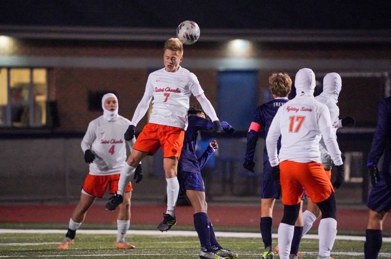 St. Charles East's Logan Lewarchick (7) goes up for a header against New Trier during the class 3A St. Charles North Boys Soccer Supersectional match at St. Charles North High School on Wednesday, Nov. 1, 2023.