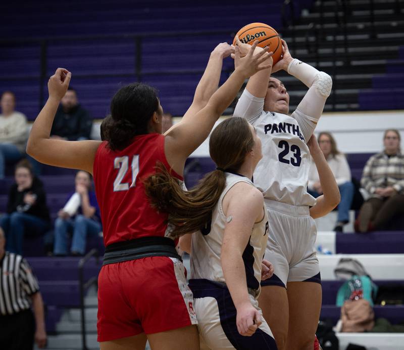 Manteno's Maddie Gesky takes in a rebound over Streator's Alexis Thomas, left, in a game on Monday, December 8, 2025.