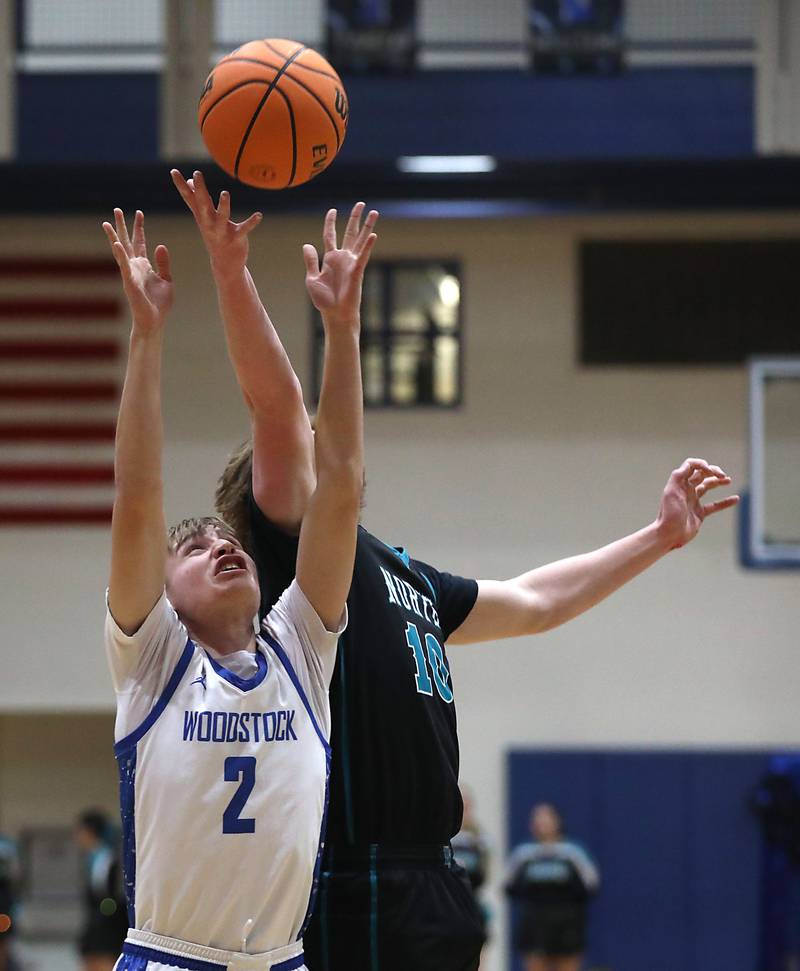 Woodstock's Collin Stock battles with Woodstock North's Brady Rogers for a rebound during a Kishwaukee River Conference boys basketball game on Wednesday, February. 18, 2026, at Woodstock High School.