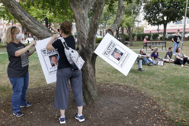 Jackie Jacobs, left, and Kimberly McClain hang wanted signs in a nearby tree calling for elected officials to support Senate Bill 2190 to repeal parental notification for terminated pregnancies during a rally for abortion rights on the historic Woodstock Square on Saturday, Oct. 2, 2021, in Woodstock.