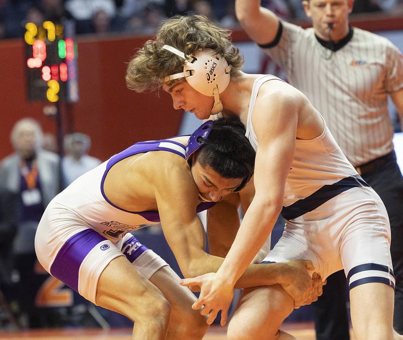IC Catholic’s Max Cumbee (right) and Rochelle’s Xavier Villalobos compete in the 126 pound weight class of the 2A state individual wrestling finals Saturday, Feb. 22, 2025, at State Farm Center in Champaign.