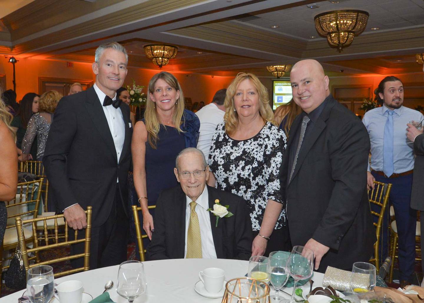 The Greater Joliet Area YMCA honored Joliet native Bill Lauer (center, seated) longtime member and volunteer of the YMCA, at its gala on Feb. 24 February with the creation of the William R. Lauer Service to Youth Award and the establishment of the William R. Lauer Endowment Fund. Bill Lauer is pictured with his family, from left: Chuck Kinder, Patti Lauer, Bill Lauer, Sue Melone and Lou Melone.