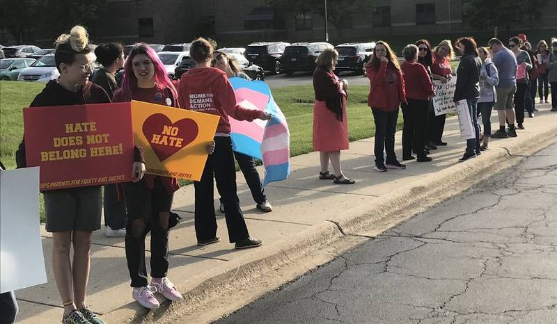 People picket before a Batavia school board meeting Tuesday, urging the district to do more to improve diversity, equity and inclusion for students, including racial minorities, and transgender and gay students.