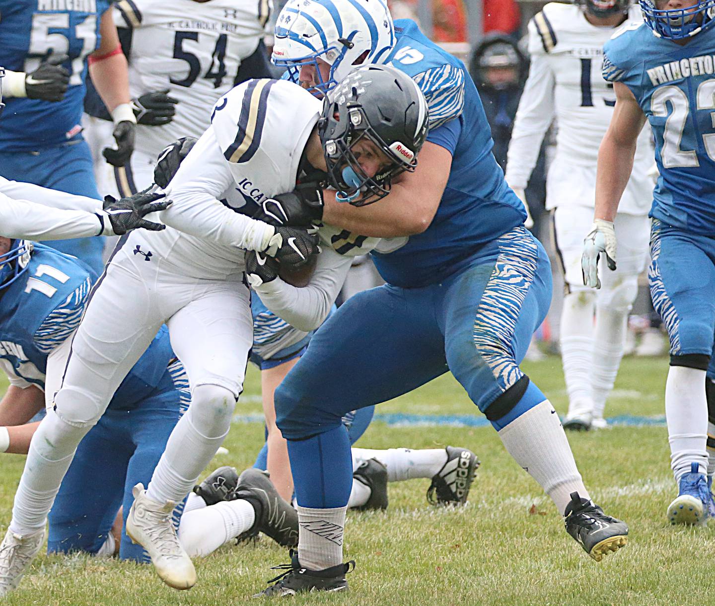 IC Catholic's Joey Gliatta (33) runs the ball as Princeton's Payne Miller (75) makes a tackle in the Class 3A Quarterfinal game on Saturday, Nov. 12, 2022 in Princeton.