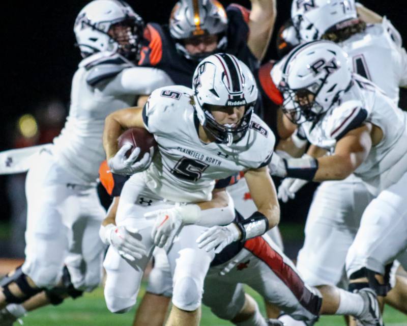 Plainfield North's Jack Tota (5) runs up the middle during football game between Plainfield North at Minooka.   Oct 6, 2023.