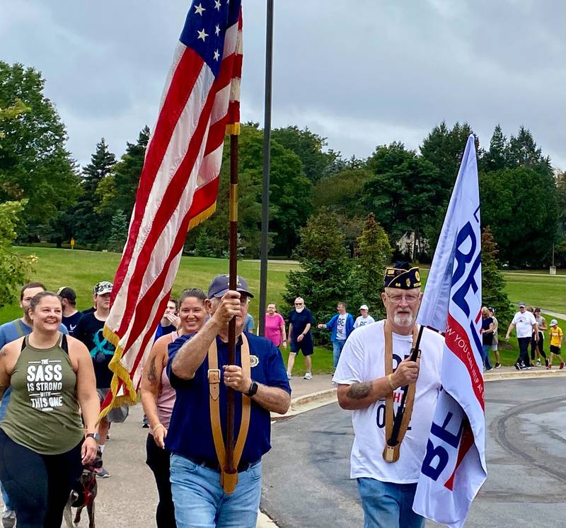 U.S. army veteran Jim Hupke, of DeKalb, who served in the Vietnam War, holds the American flag to lead the Be the One Walk to spread awareness about veteran suicide rates. The 2.2-mile trek to mark the roughly 22 veterans who die by suicide yearly set out from Northwestern Medicine Health and Wellness Center, 626 Bethany Road, DeKalb, and drew a large crowd Sunday, Sept. 22, 2024.