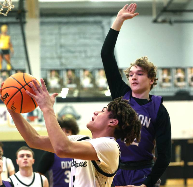 Sycamore's Josiah Mitchell goes to the basket in front of Dixon’s Gabe Rowley during their game Tuesday, Jan. 14, 2025, at Sycamore High School.